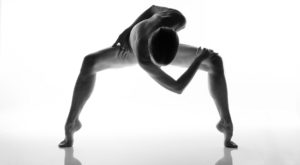 Figurative Nude cleverly devoid of nudity on a high key background with artistic pose