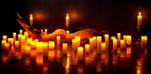 Beautiful artistic classy nude form surrounded by candles